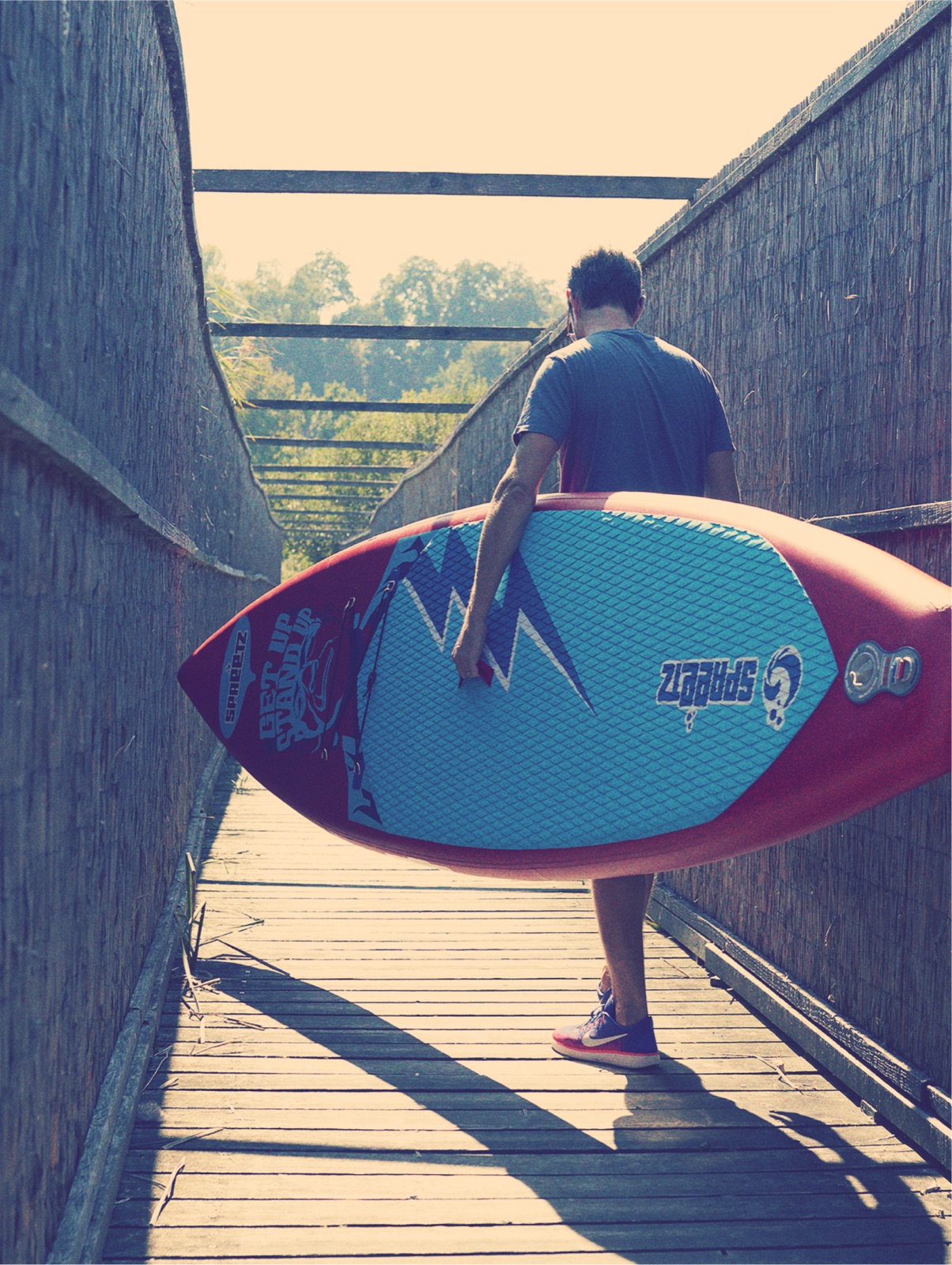 A rider carrying a Spreetz paddle board